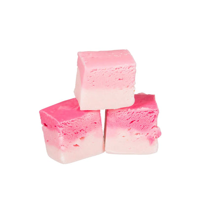 Three chunks of The Fudge Factory Candyfloss Flavoured Nougat on a white background.