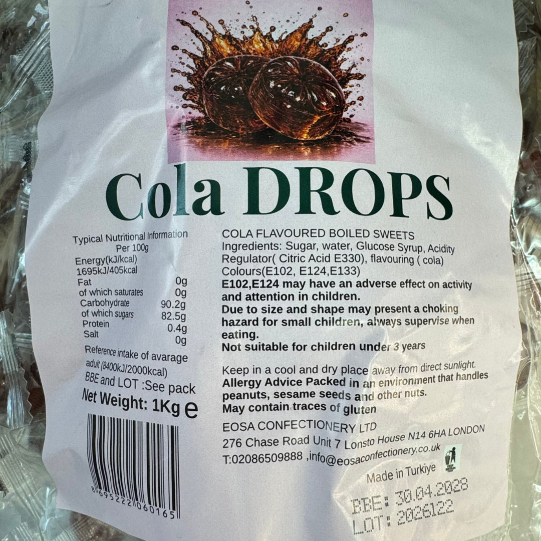 A close-up of a bag of Cola Drops cola-flavoured boiled sweets, showing the front packaging with product name, ingredients, nutritional information, barcode, and handling advice on a white background.