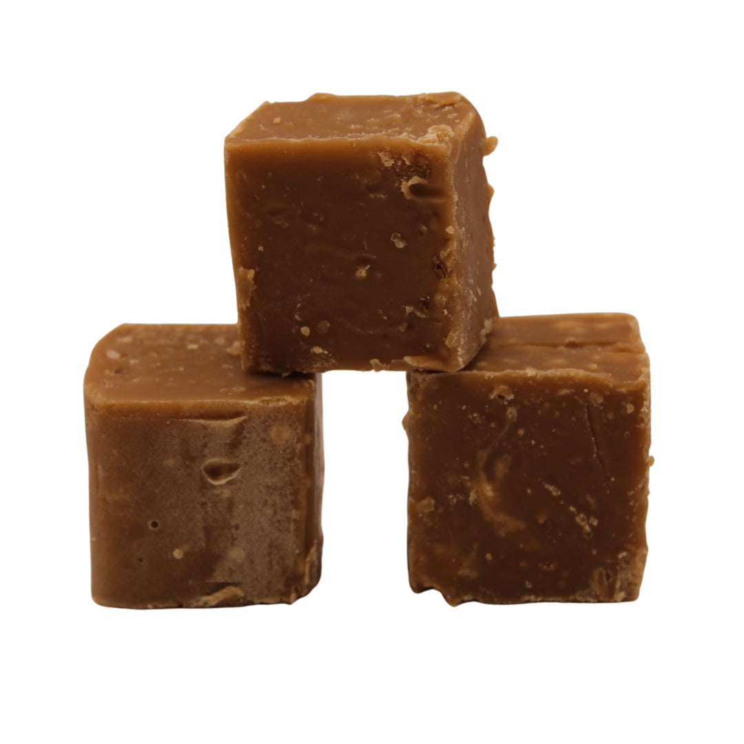 Three cubes of The Fudge Factory Salted Caramel stacked on a white background
