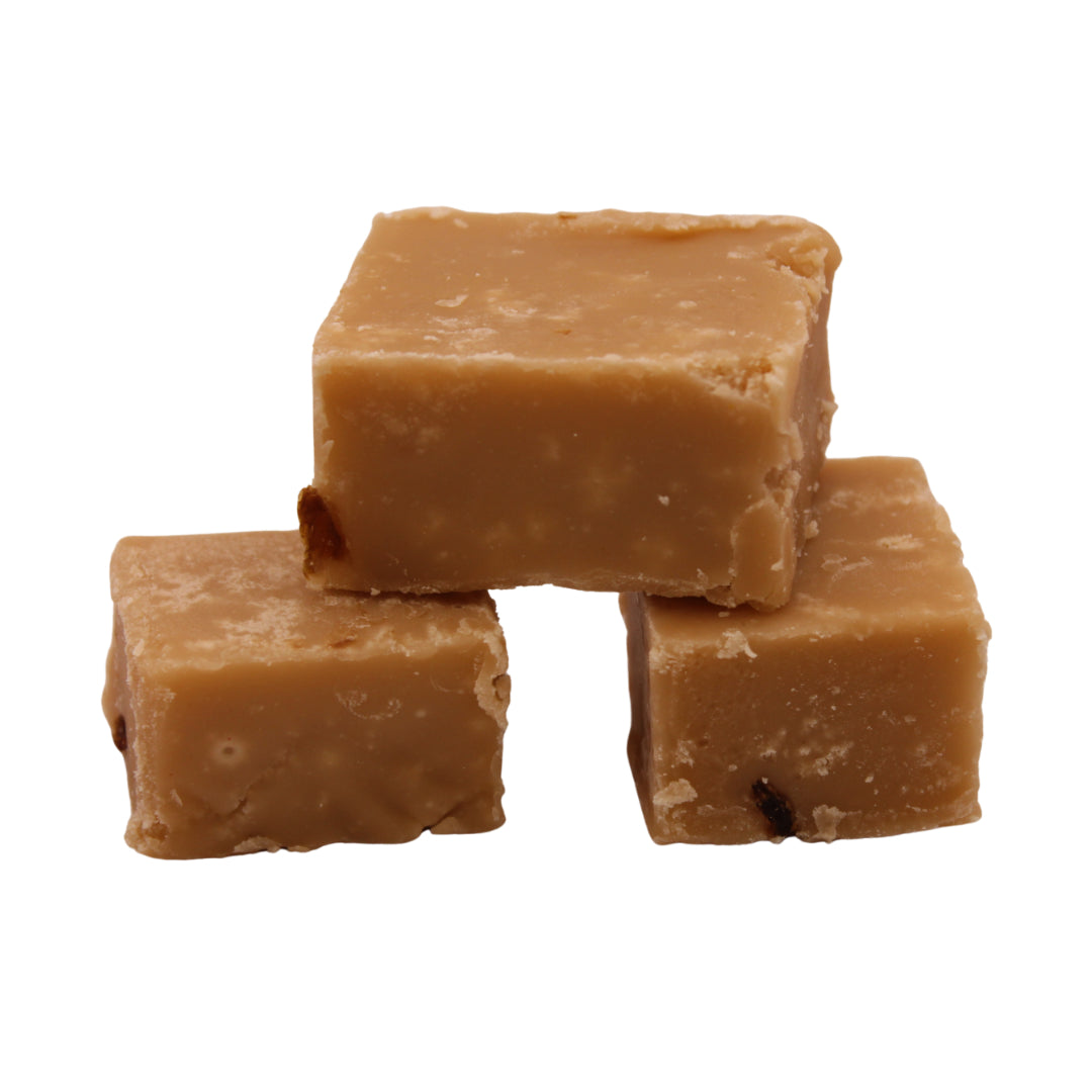 Three pieces of The Fudge Factory Rum and Raisin stacked on a white background