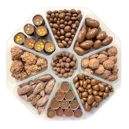 Lollypop Lane platter filled with an assortment of milk chocolate sweets with the lid off on a white background.