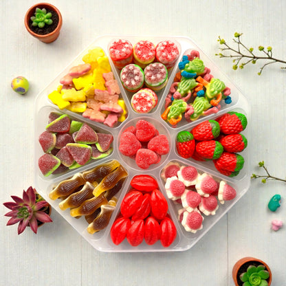 Lollypop Lane sweet platter filled with jelly filled sweets on a white wooden table with various succulents.