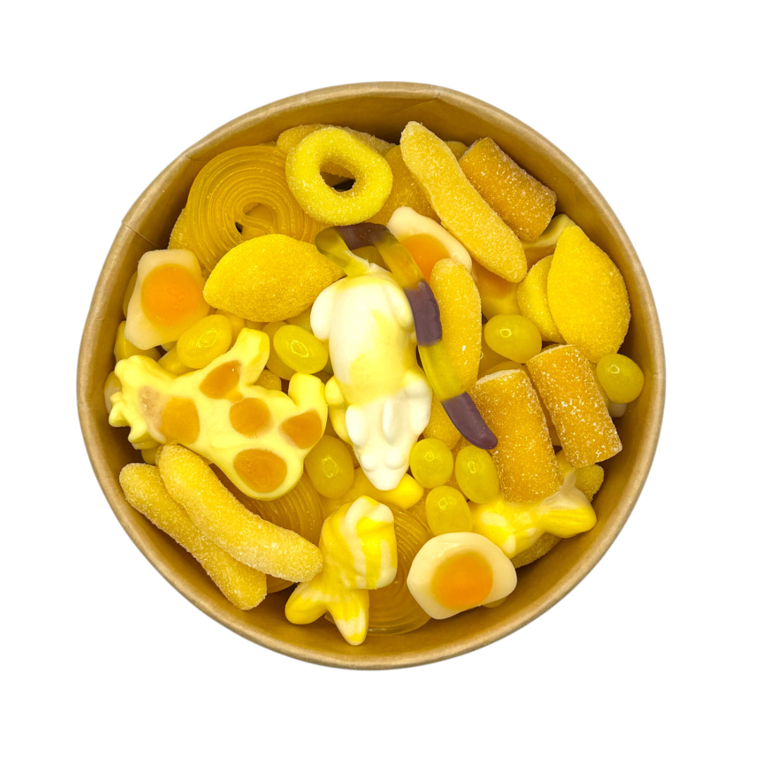 Lollypop Lane sweet bowl filled with yellow sweets on a white background.