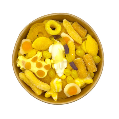 Lollypop Lane sweet bowl filled with yellow sweets on a white background.