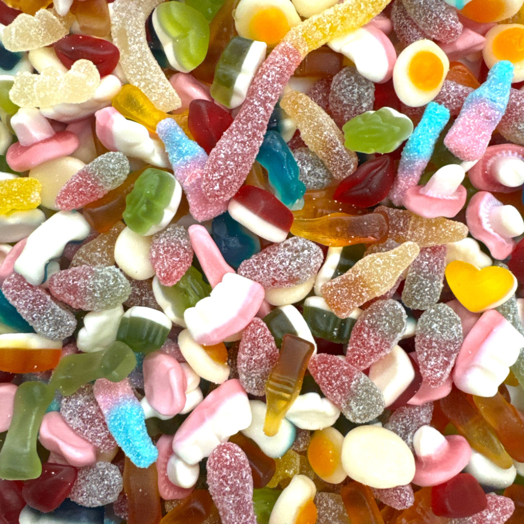 Assorted colorful gummy candies including worms, bears, and other shapes.