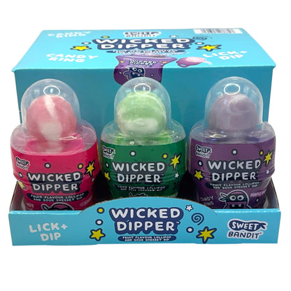 Three Wicked Dipper lollipop containers in a display box with colorful packaging.