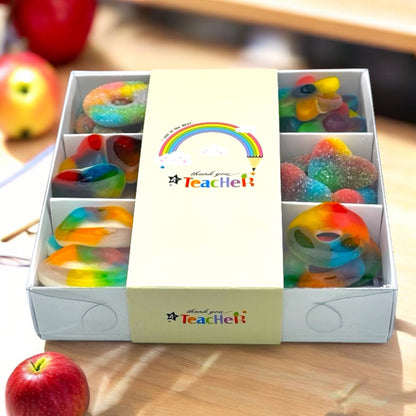 Box of colorful gummy candies with 'Thank you Teacher!' message on a wooden surface.
