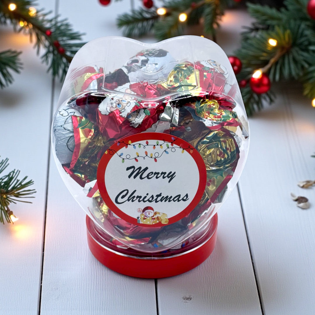 Lollypop Lane Milk Chocolate Christmas Assortment Heart Jar 200g. The background features a Christmas deco table