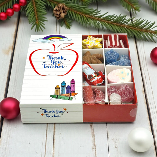 Lollypop Lane Teacher Christmas Gift, Festive Sweet Selection. The background features a wooden table with Christmas decorations.
