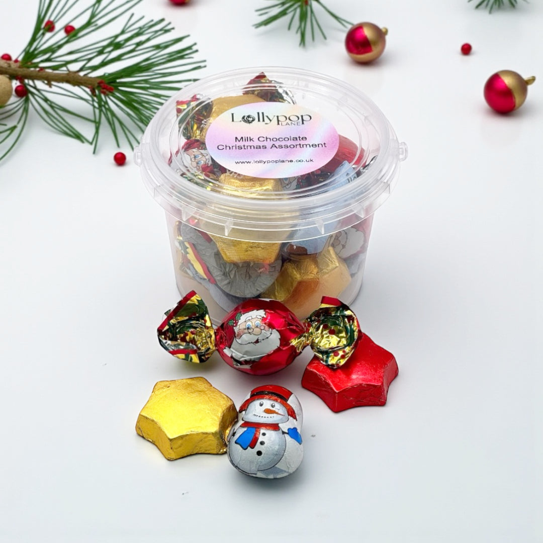 Lollypop Lane Milk Chocolate Christmas Assortment Bucket 180g surrounded by Xmas foliage